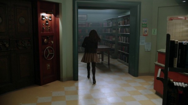 Belle in the library with elevator door (The Outsider-2x11)