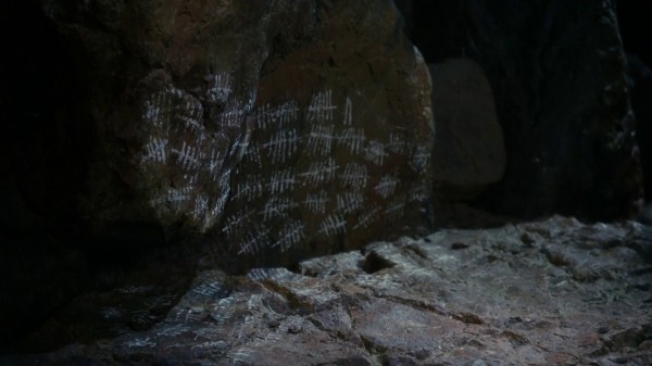 Tally marks on cave wall (3x05 Good Form)