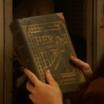 Once Upon a Time podcast 5x17 Her Handsome Hero - Belle holding Her Handsome Hero book found in Gaston's locker