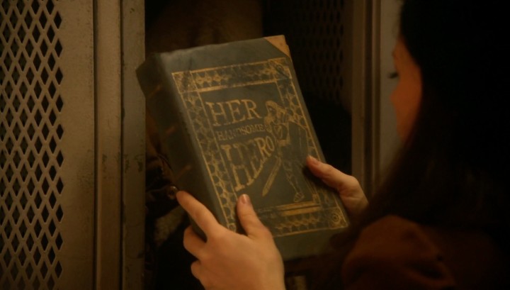 Once Upon a Time podcast 5x17 Her Handsome Hero - Belle holding Her Handsome Hero book found in Gaston's locker